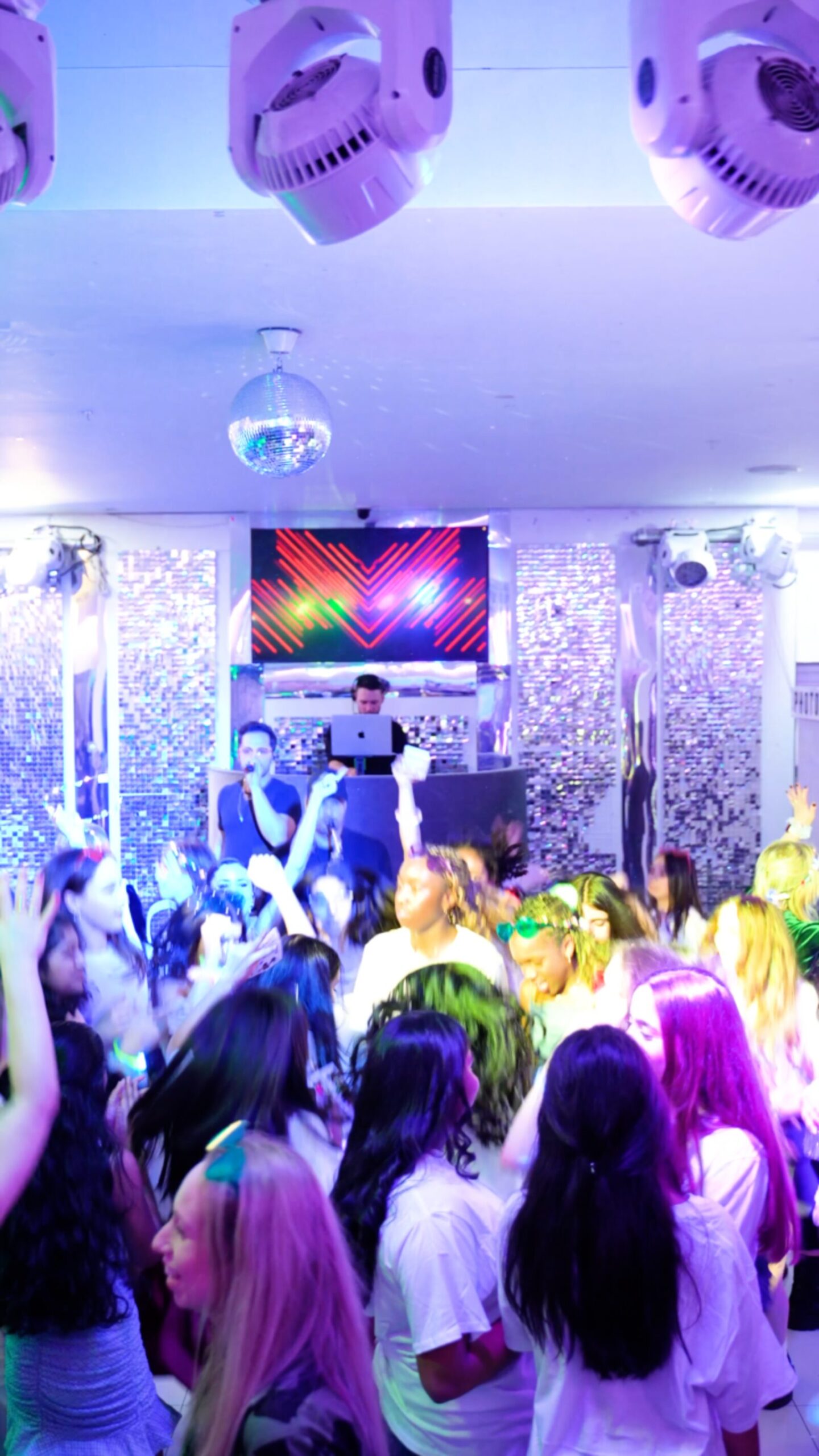 Guests dancing under red lighting